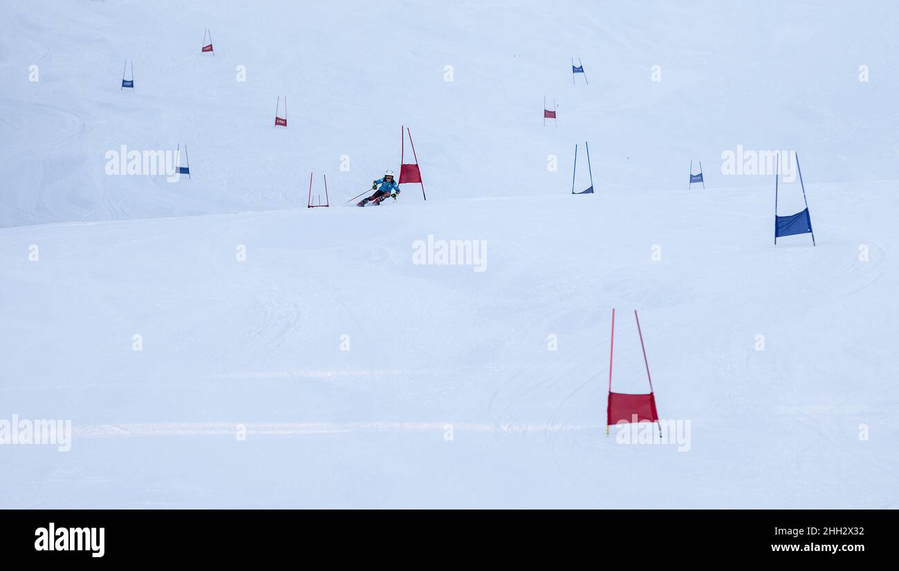Children ski racing on a slalom track. Alpine skiing competition. Stock Photo