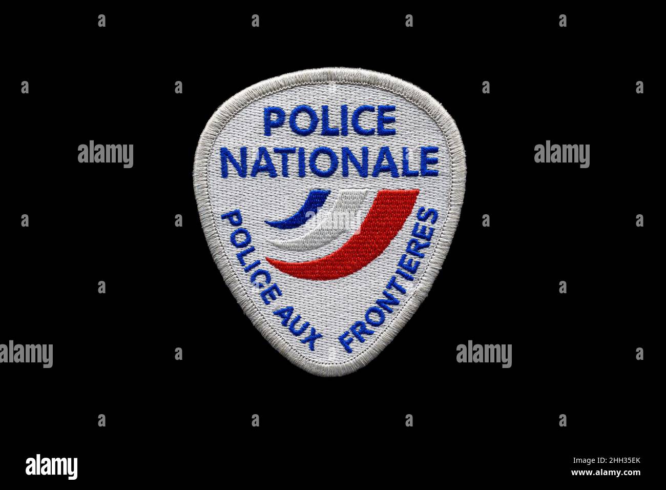 Official badge of the French Border Police, responsible for border control in France, isolated on black background. Stock Photo