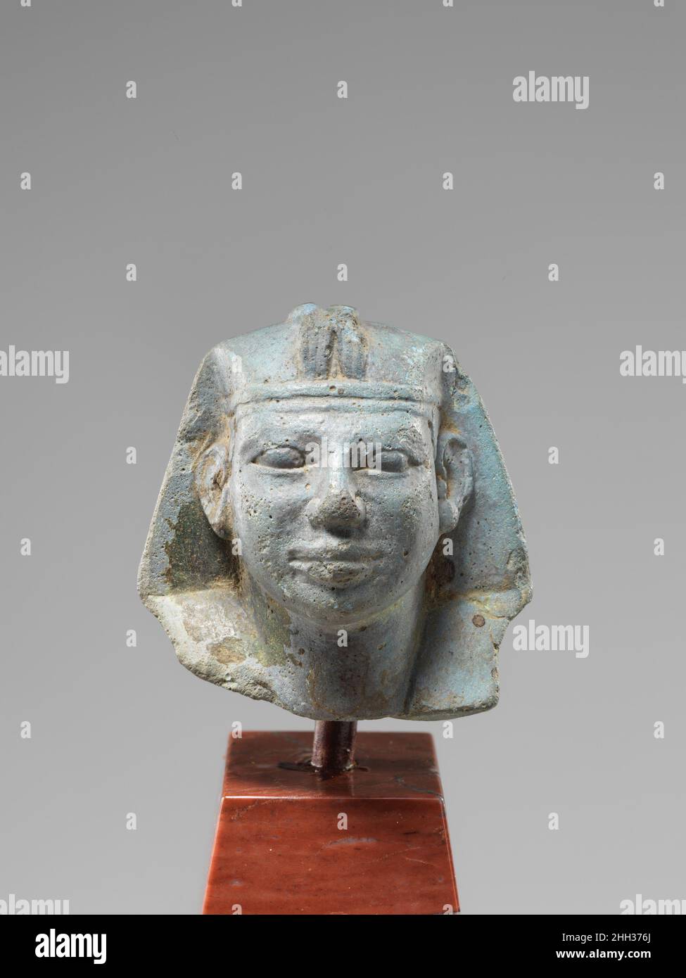 Head of a Kushite King ca. 747–664 B.C. Third Intermediate Period When rulers of the Kingdom of Kush in Nubia became pharaohs of Egypt, they adopted the Egyptian conventions of representation. However they added distinctive elements, such as the double uraei worn on the nemes headdress shown here, to express their Nubian character.. Head of a Kushite King. ca. 747–664 B.C.. Egyptian blue. Third Intermediate Period. From Egypt. Dynasty 25 Stock Photo