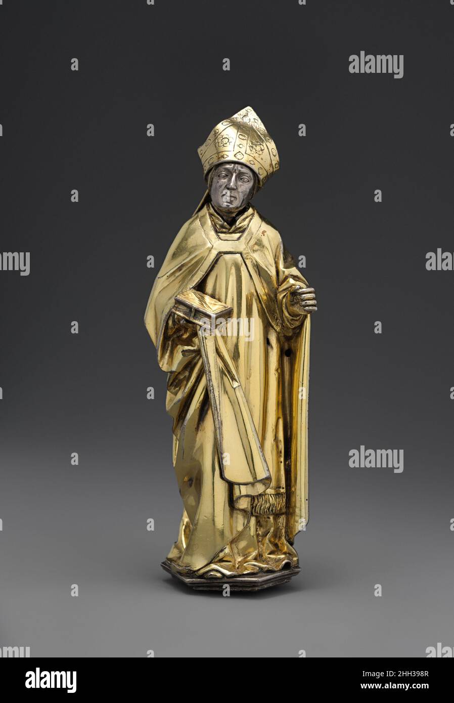Standing Bishop ca. 1510 Hans von Reutlingen German This finely worked figure appears to have come from the immense bust reliquary of Saint Lambert commissioned by the prince-bishop Erard de La Marck for the now-destroyed cathedral of Saint Lambert in Liège. Created by the Aachen goldsmith Hans von Reutlingen and his workshop beginning in 1508, it was consecrated on April 22, 1512. The bishop, who originally held a crozier in his left hand, probably represents a locally venerated bishop saint.. Standing Bishop. Hans von Reutlingen (German, Aachen, 1465–1547) or Workshop. German. ca. 1510. Silv Stock Photo