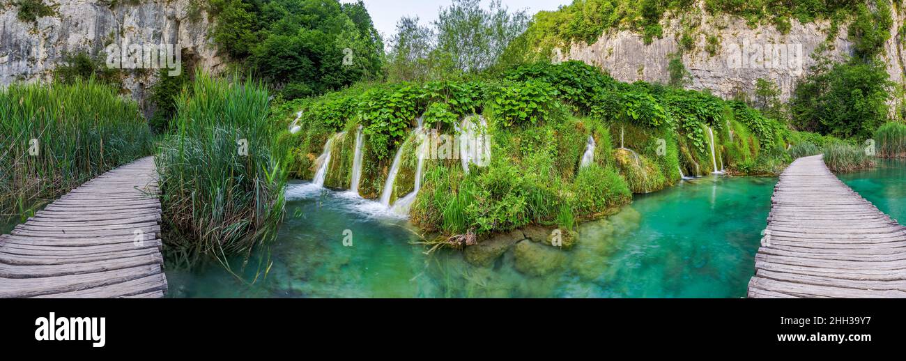Plitvice, Croatia - Panoramic view of a wooden walkway in Plitvice Lakes National Park on a bright summer day with crystal clear turquoise water, smal Stock Photo