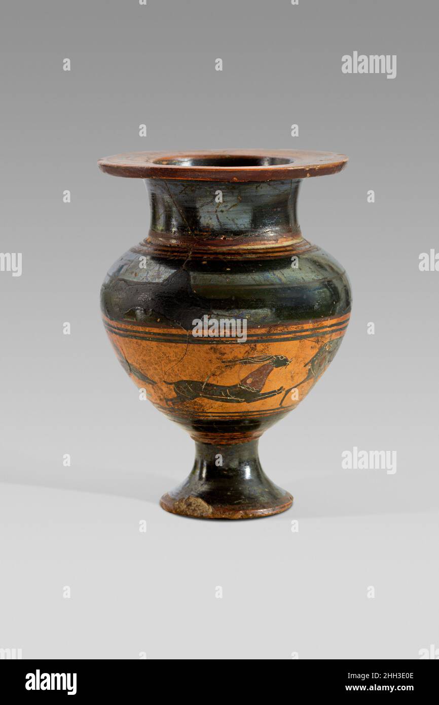 Terracotta lydion (perfume jar) end of the 6th century B.C. Greek, Attic As indicated by its name, the lydion (perfume vase) originated in Lydia, a region in western Anatolia. Its capital city Sardis was an important center of cross-cultural interactions between Greece and the Near East. This lydion is exceptional, as it is an unusual shape in the Attic repertoire, and exceedingly rare with figural decoration. In addition to the shape, the decoration further emphasizes a connection with the Near East, where bands of animals were common.. Terracotta lydion (perfume jar). Greek, Attic. end of th Stock Photo
