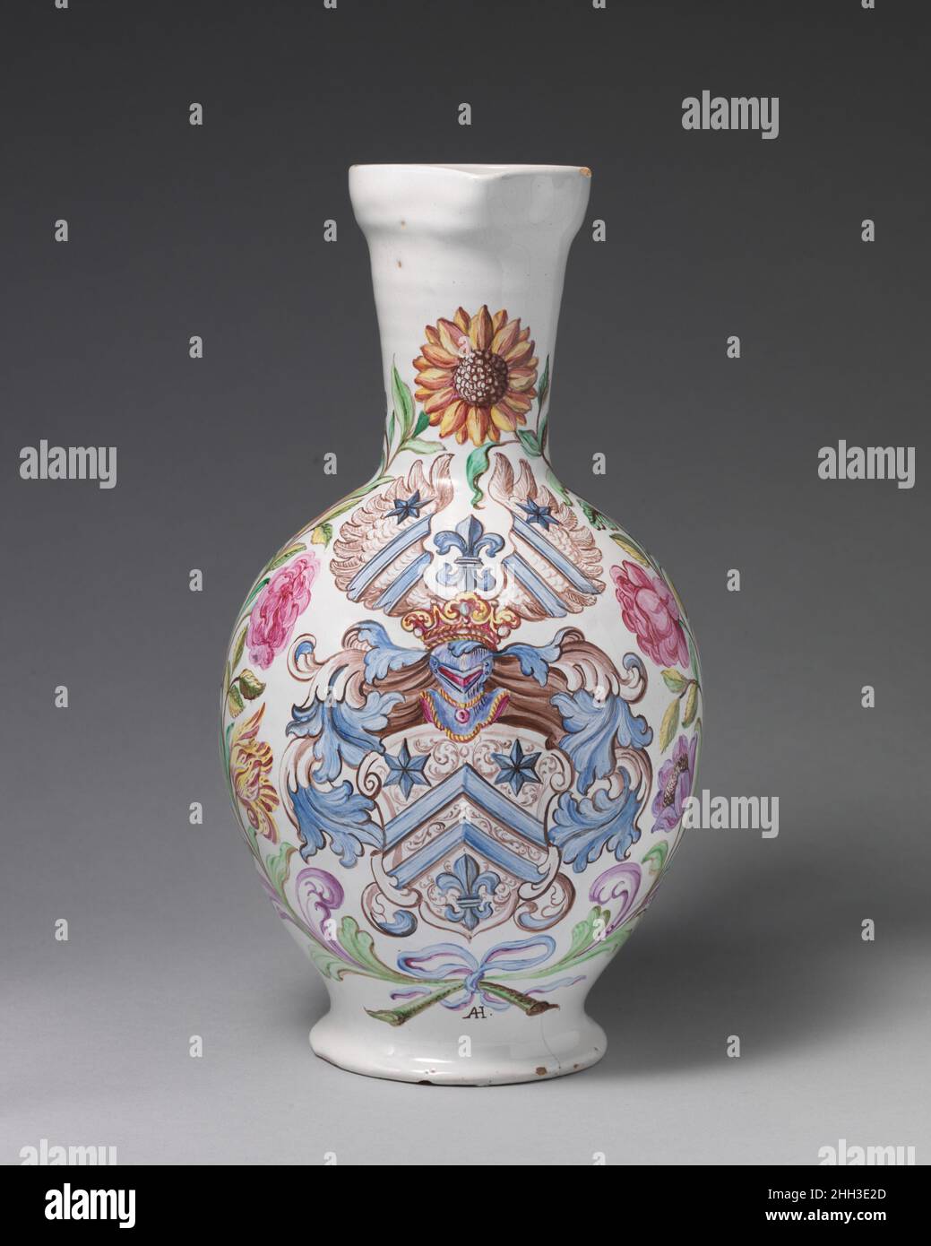 Jug with coat-of-arms of the Cleminius Family ca. 1700 Abraham Helmhack The end of the Thirty Years War in 1648 saw the revival of domestic industries such as decorated faience wares, which catered to the German bourgeoisie. Abraham Helmhack (1654–1724) was a Hausmaler, or independent decorator, who specialized in biblical motifs, flowers, and coats-of-arms. This example, painted for the Cleminius family, features a coat-of-arms set within a lavish floral border. His monogram AH can be found at the foot of the vessel.. Jug with coat-of-arms of the Cleminius Family. German, Frankfurt with Nurem Stock Photo