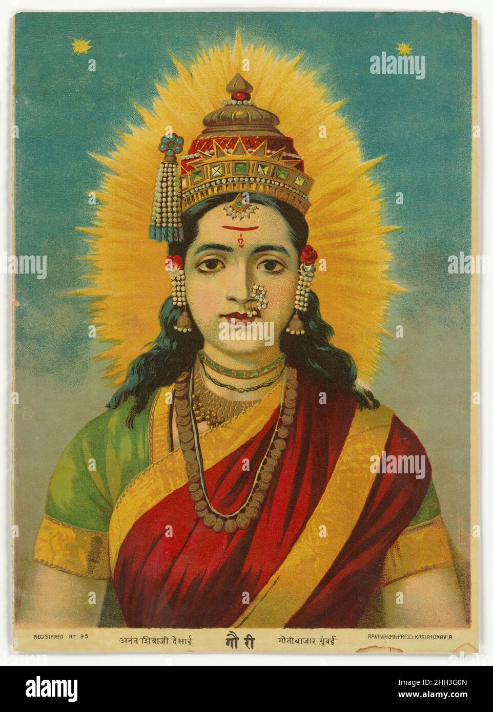 Gauri 1894–99 India, Maharasthra, Pune Gauri is an expression of a tender form of Parvati, the wife and consort of Shiva. In this image, Gauri is represented portrait-like, as if a depiction of a young woman of beauty, not of divinity. Her ‘other’ status is asserted only by the crown she wears, which along with her radiant halo, defines her divine status. In all other respects, she could be mistaken for a young woman prepared for her wedding day.The lower register of the print declares the goddess’s name in devanagari script, along with the name of the press 'Ravi Varma Press, Karla-Lonavia', Stock Photo