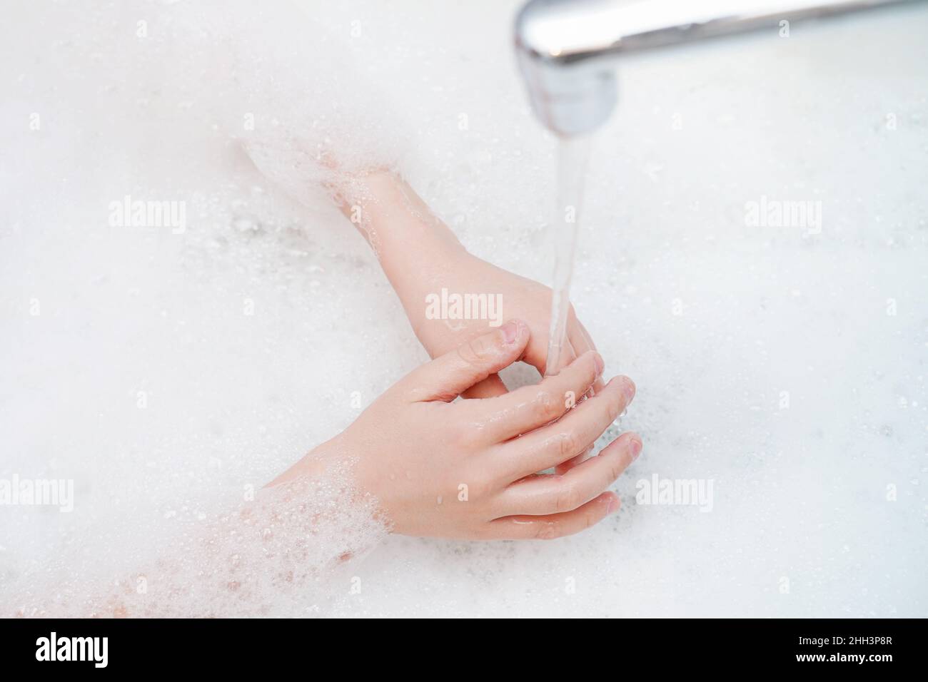 Child washing hand in bathroom. Medicine, hygiene concept. Stock Photo