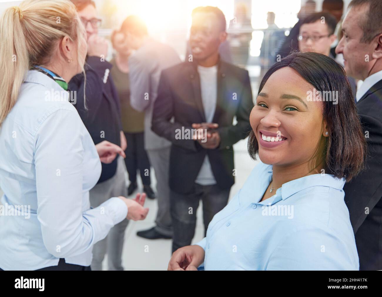 Portrait of creative business team standing together and laughing ...