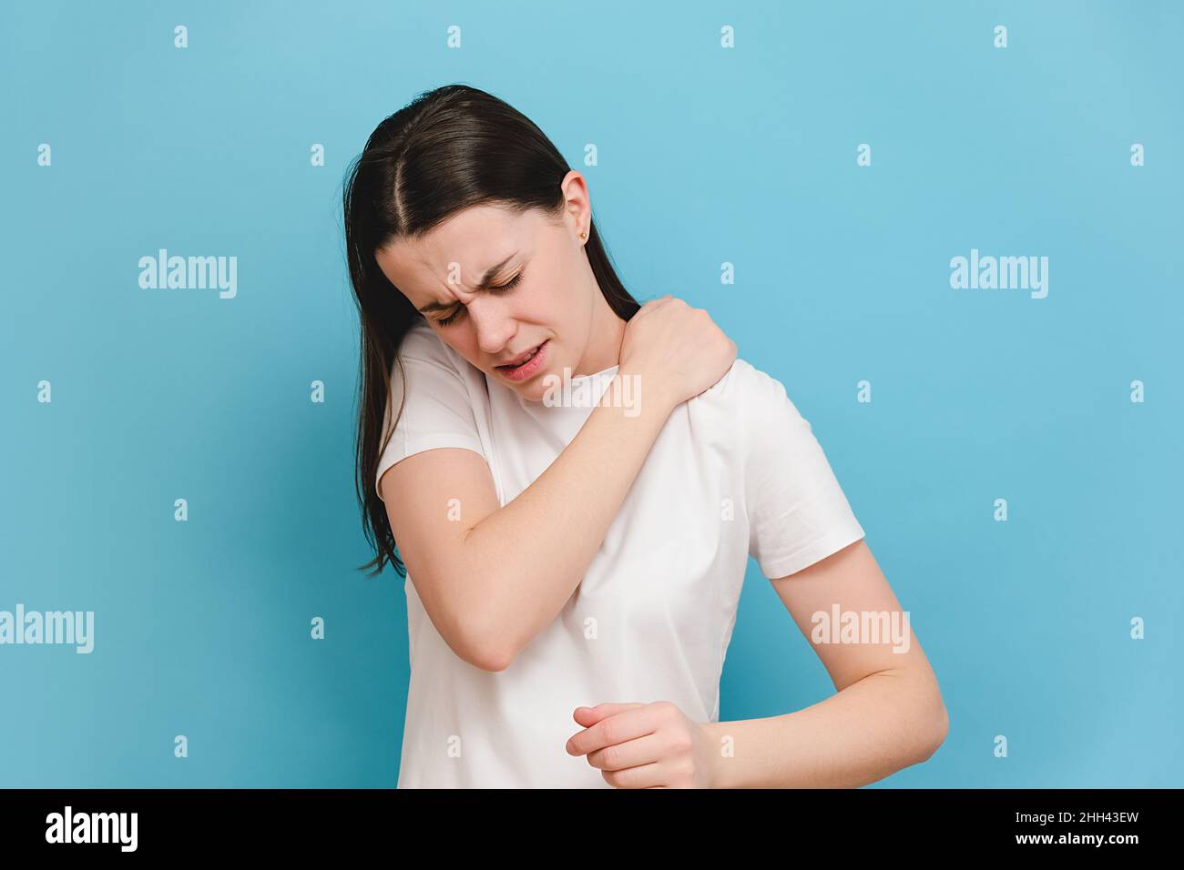 Tired upset young woman massaging hurt stiff neck, fatigued