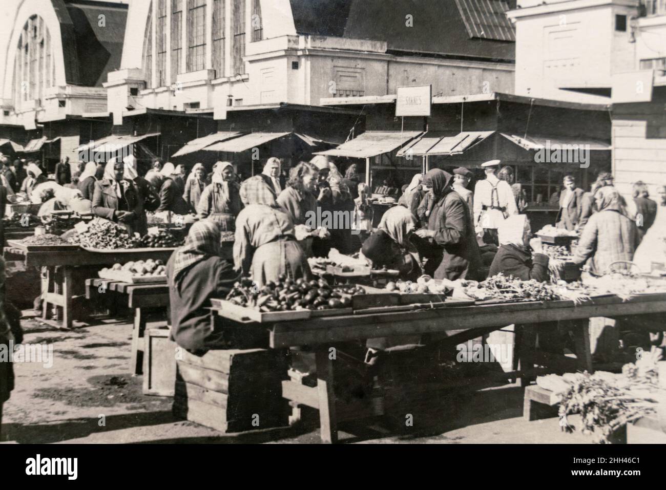 Latvia - CIRCA 1940s: Vintage archive photo of Riga Central Market. People trading all kinds of vegetable on a street market Stock Photo