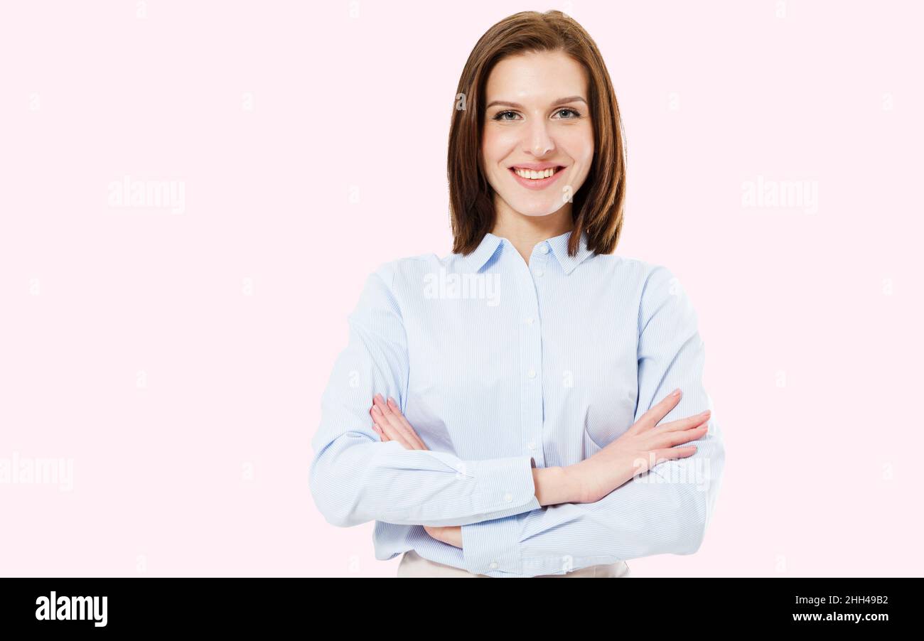 image of pretty smile brunette woman standing with arms crossed on pink background Stock Photo