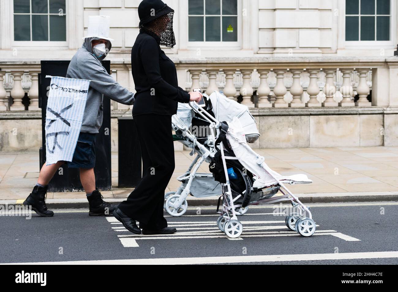 Extinction Rebellion demonstration in London uses powerful white pram imagery to draw attention to the impact of climate change on young / unborn children Stock Photo