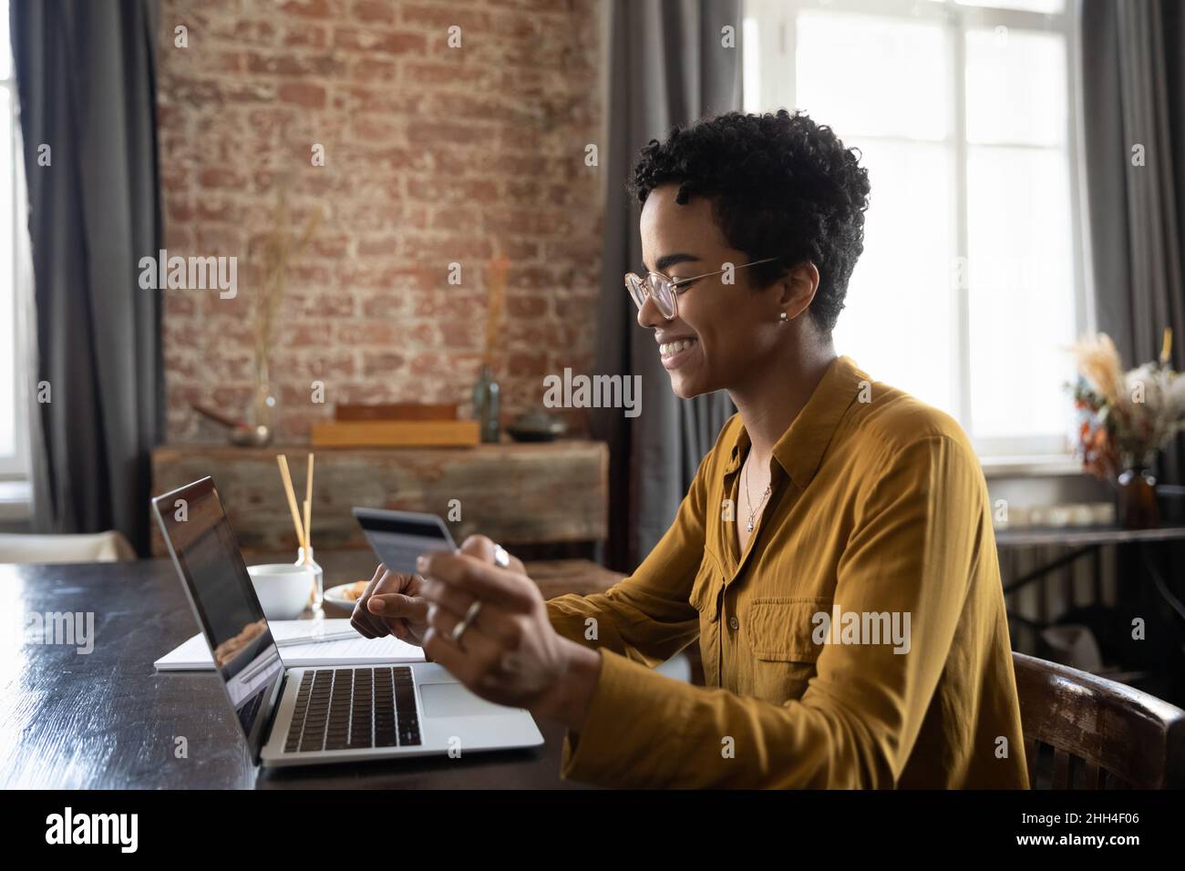 Happy young woman using laptop, credit card for online shopping Stock ...