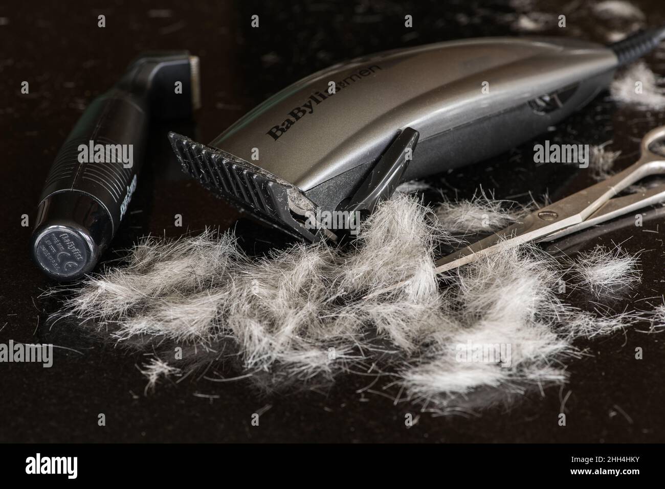 Home hairdressing with a BaByliss hair trimmer/cutter Stock Photo Alamy