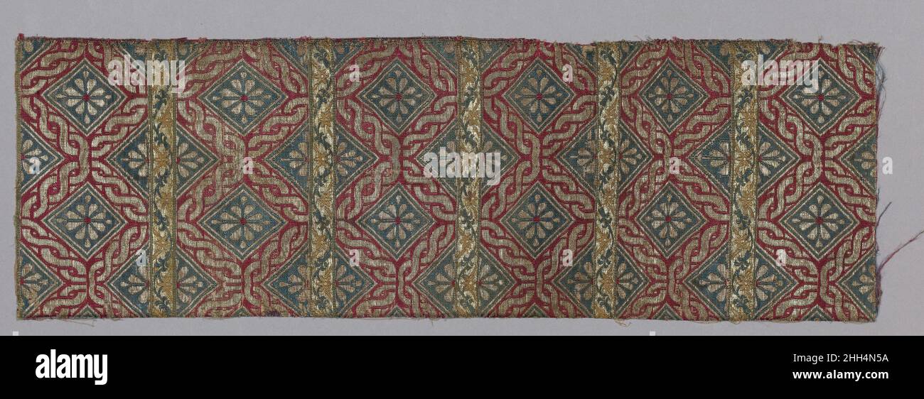 Textile Fragment first half 16th century Expensive materials were woven in a sophisticated technique, using silver and metal-wrapped silk, to produce a rare and precious type of Ottoman silk fabrics called seraser. Few examples survive from the early period of production dating from the first half of the sixteenth century. They are usually woven in designs and motifs quite different from the typical Ottoman artistic language, organized in narrow horizontal bands of small-scale decoration. Here, blue diamond-like rectangles, each bearing eight-petalled silver blossoms, are framed by red borders Stock Photo