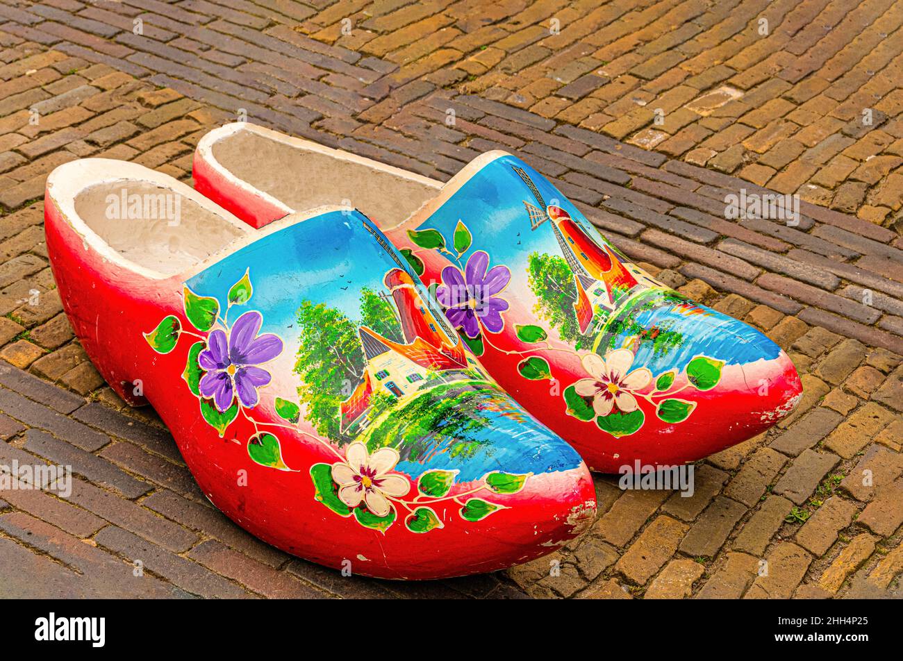 old street in the historic center of the city of Breda with traditional multIcolored swedish shoes. Stock Photo