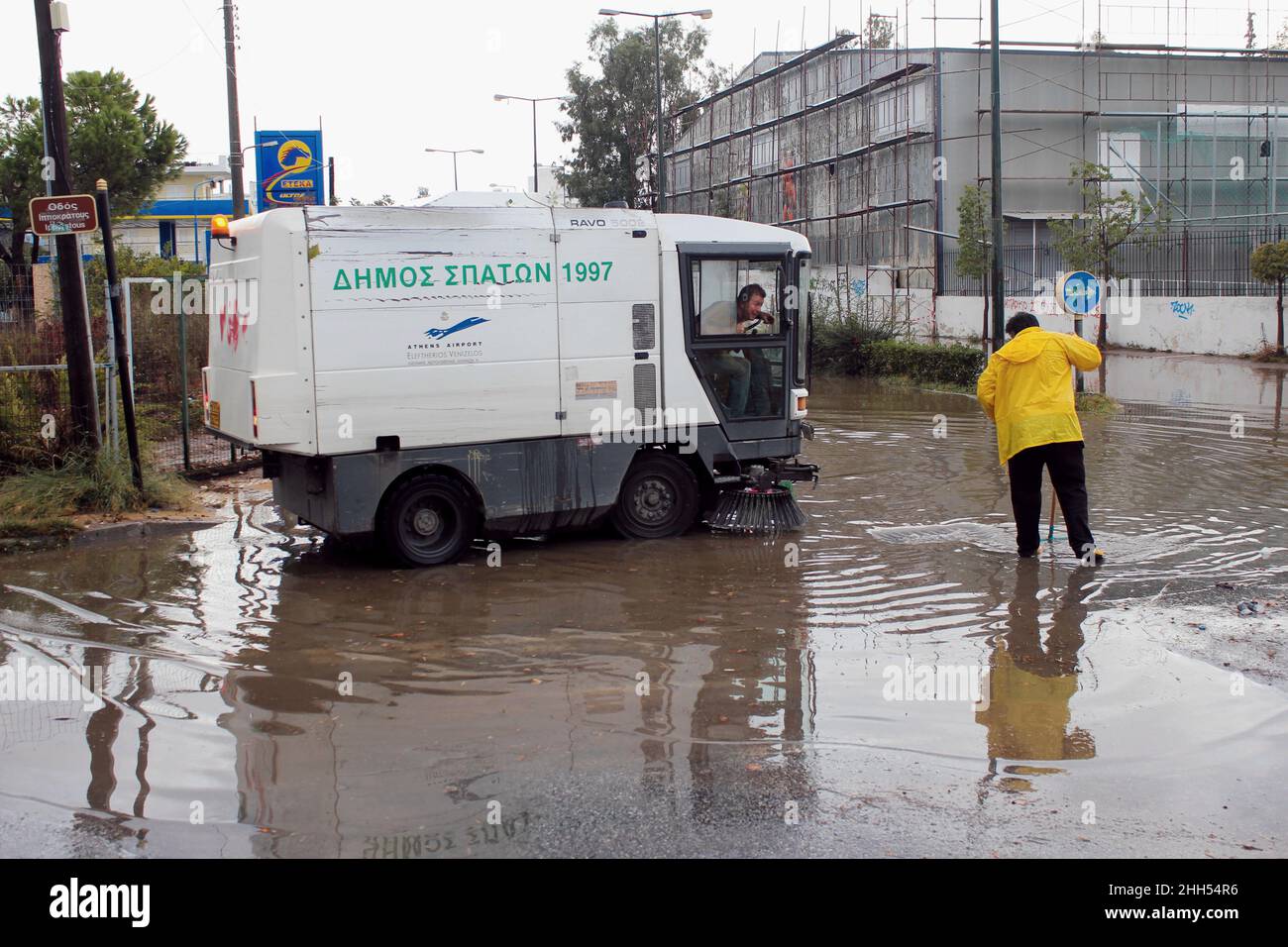 Cleaning up flooded street after heavy rainfall - Spata, Attica, Greece, October 31 2019 Stock Photo