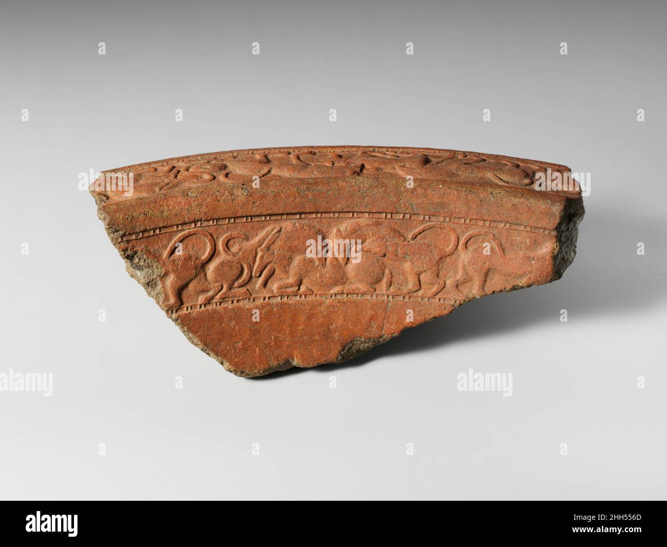 Terracotta brazier fragment ca. 540–530 B.C. Etruscan Rim fragment with a pair of lions attacking a bull and a horned deer.. Terracotta brazier fragment  251427 Stock Photo