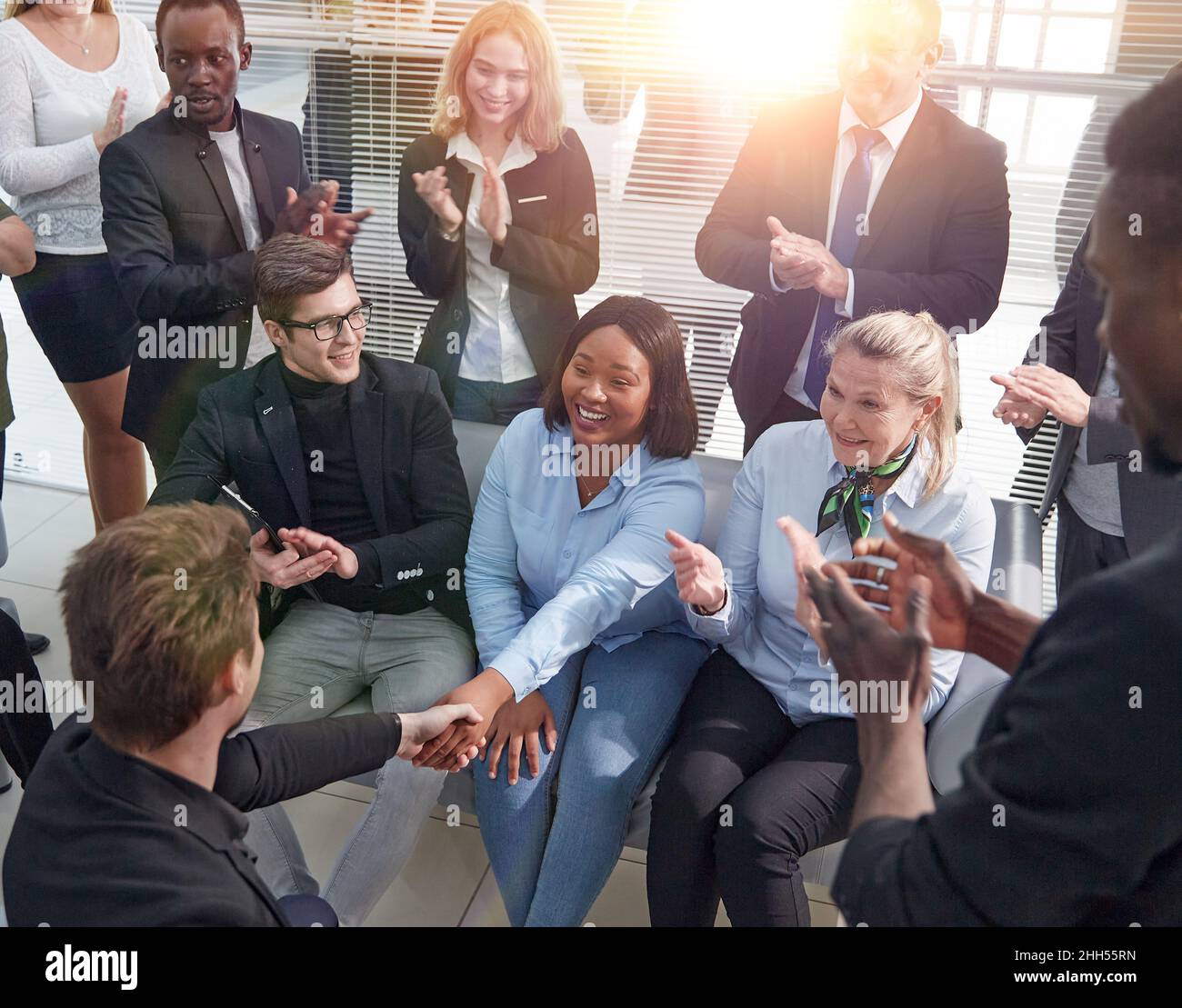 close up. employees greeting their new colleague with applause Stock