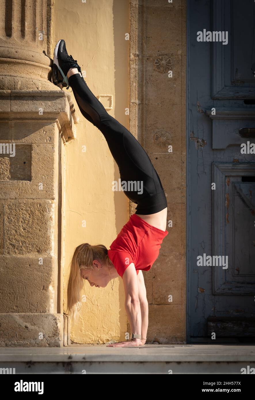 Athletic woman in sportwear doing gymnastics outdoor. Fitness girl