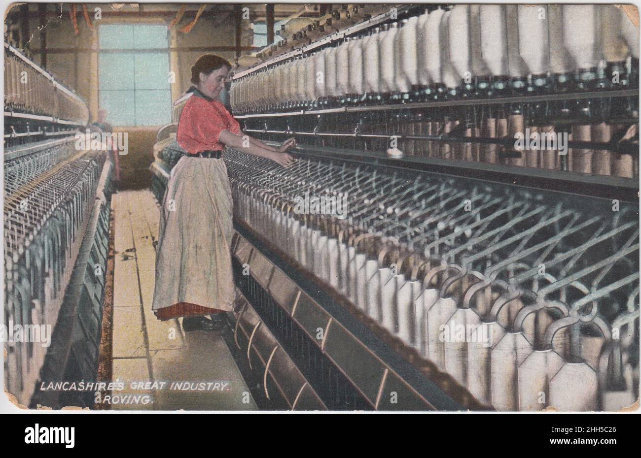 'Lancashire's great industry: Roving': Woman standing next to mill machinery. The colourised postcard was published by L. Pickles & Co. of Bradford, and was posted in 1920 Stock Photo