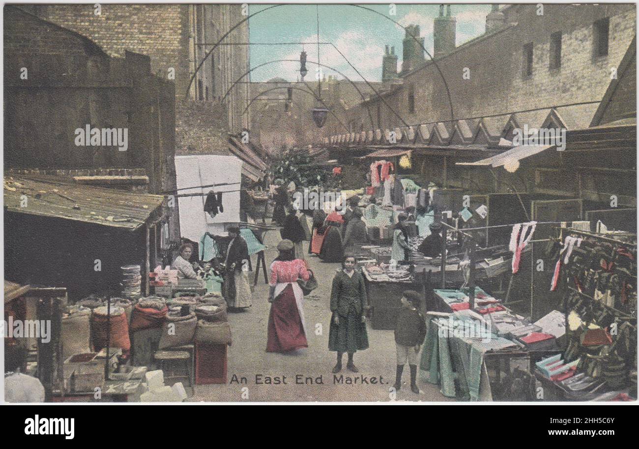 'An East End market', early 20th century: market stalls in East London