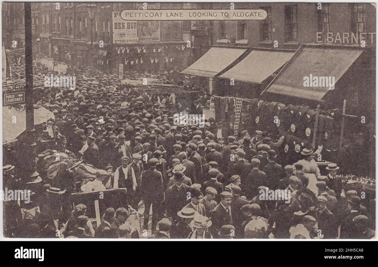 Petticoat Lane looking to Aldgate, early 20th century. Street view of Petticoat Lane Market, showing some of the stalls. The shop front of E. Barnett & Co. can be seen, as well as a poster for the 1907 silent film 'Ben Hur' Stock Photo