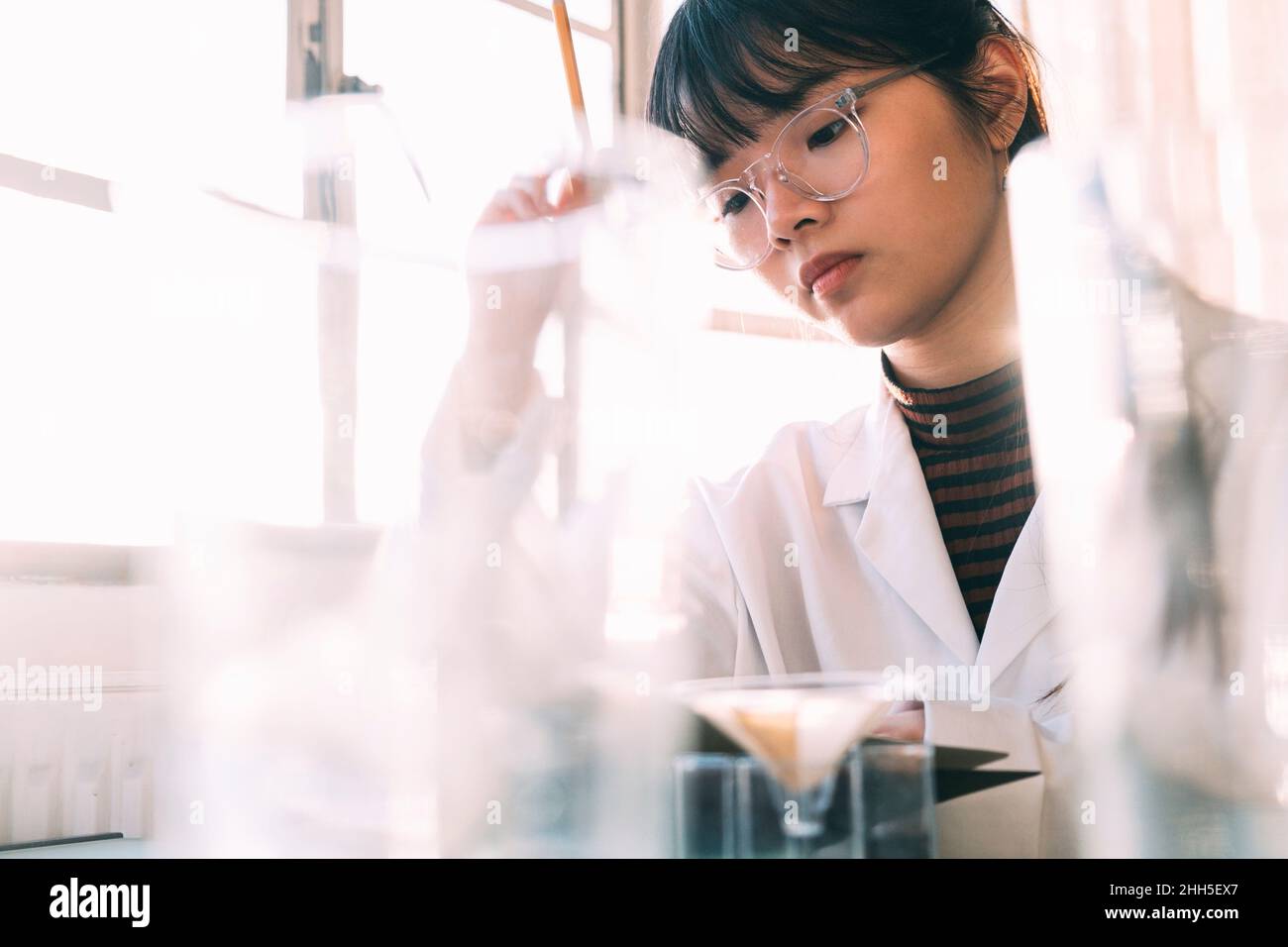 Young chemist working with concentration in laboratory Stock Photo