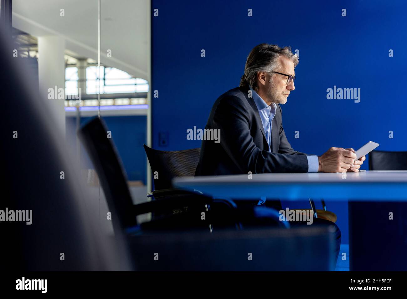 Businessman using tablet PC at workplace Stock Photo