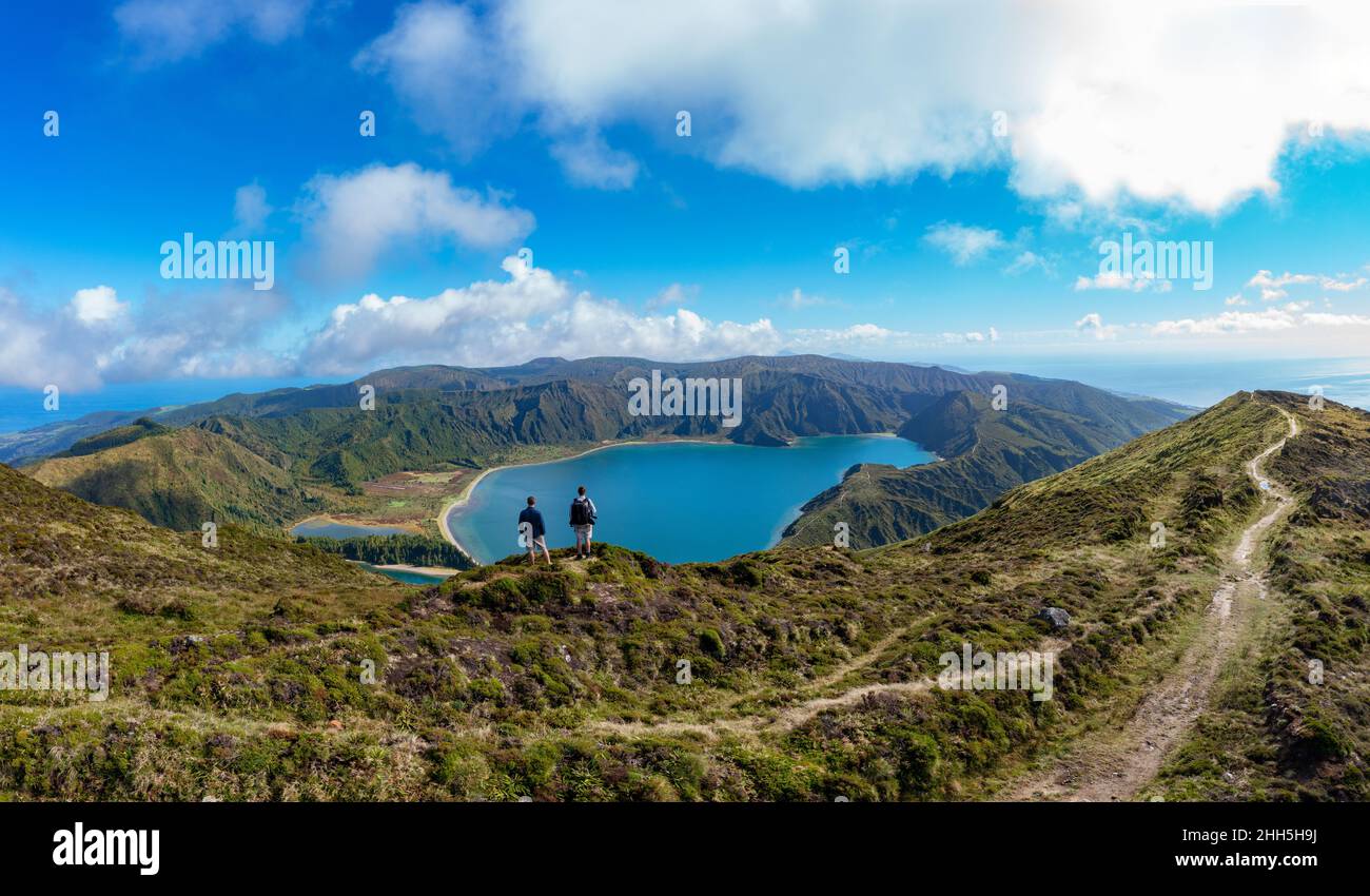 Hikers miradouro do pico da barrosa looking lagoa do fogo hires stock