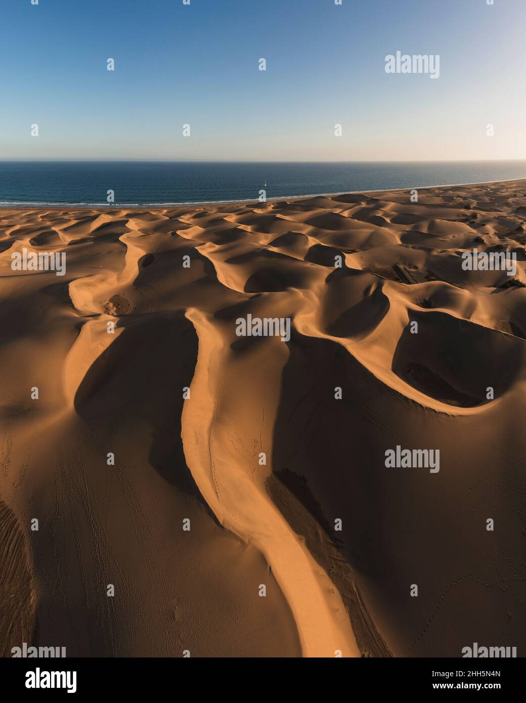 Maspalomas sand dunes by sea at sunset, Grand Canary, Canary Islands, Spain Stock Photo