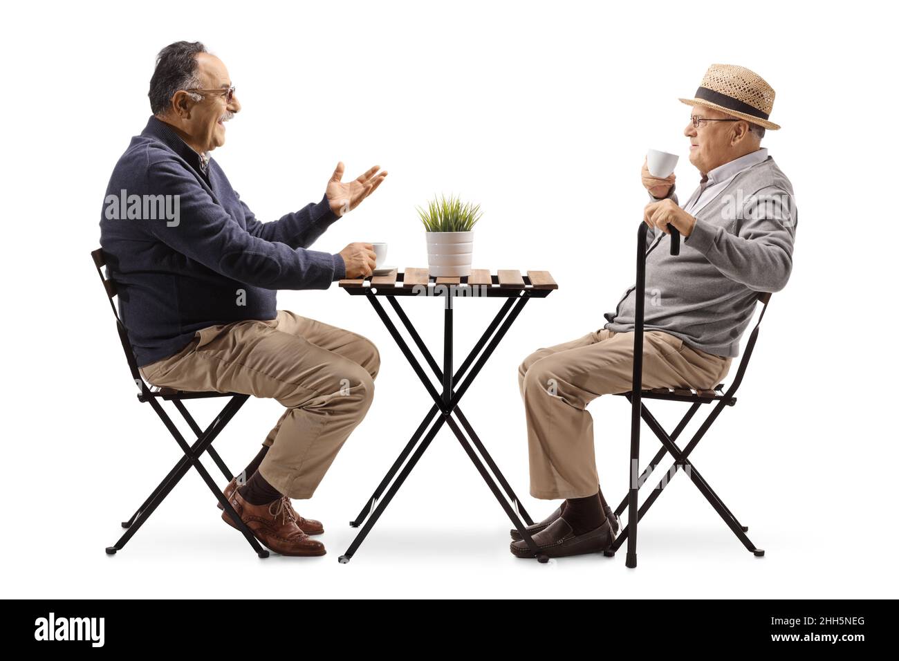 Elderly men drinking coffee and sitting at a cafe table isolated on