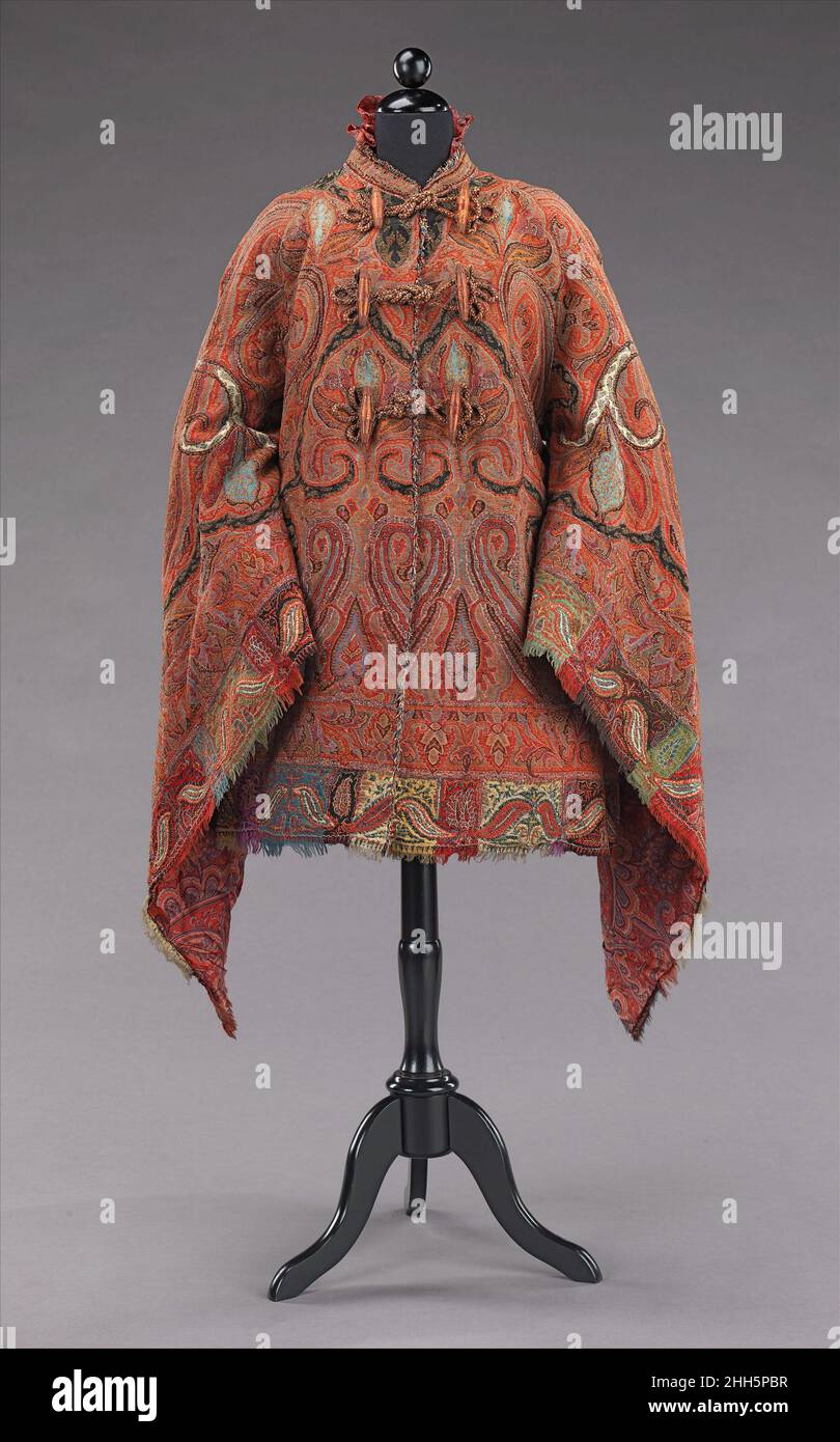 Dolman ca. 1875 American This dolman is made from a fine quality Indian shawl which is sewn to shape with beautifully symmetrical seaming and a well placed border. The theme is carried into the interior with an elaborate paisley patterned silk lining making this truly a luxury item. In the 1870s shawls lost popularity due to its immense size and the reducing expanse of skirts to help support them. Although some were retained as heirlooms, others were stitched into the more wieldy shape of the mantle.. Dolman  159426 Stock Photo