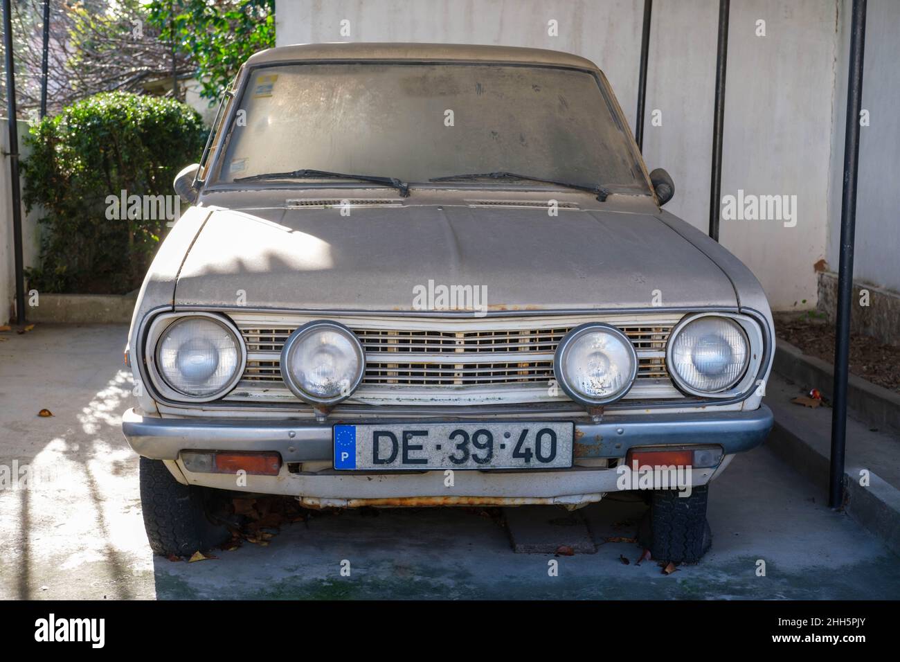 Castelo Branco, Portugal - January 09 2022: Abandoned Datsun 1200 sat under a layer of dust in Central Portugal Castelo Branco Stock Photo