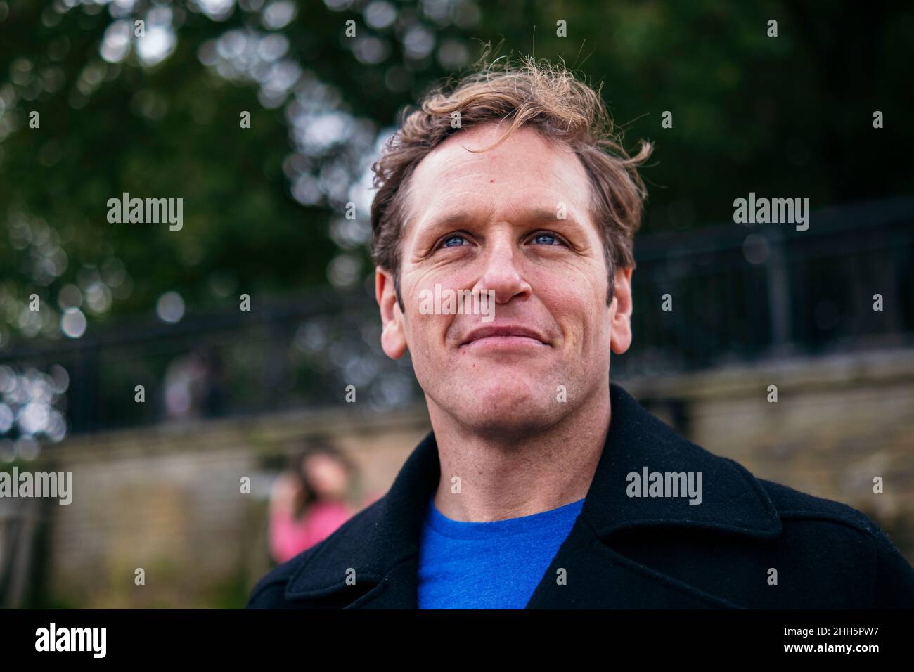 Smiling man wearing jacket looking away Stock Photo