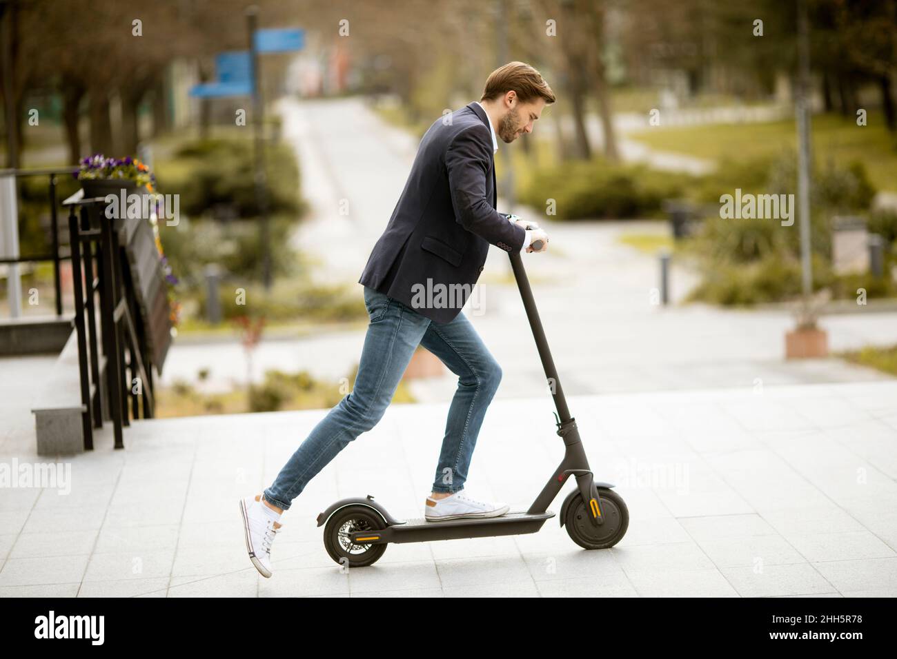 Modern man riding scooter hi-res stock photography and images - Alamy