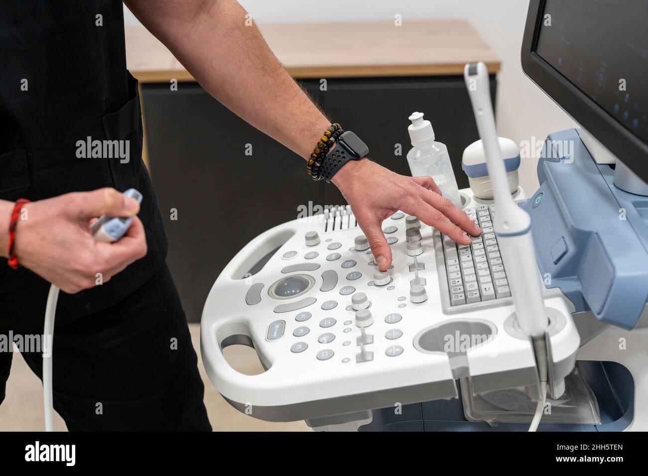 Doctor using medical equipment in clinic Stock Photo