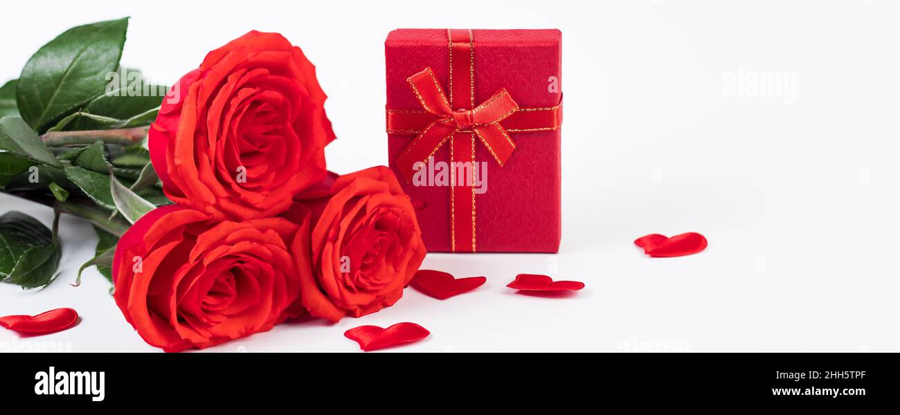 Bouquet of red roses and gift box on white background. Valentine's day ...