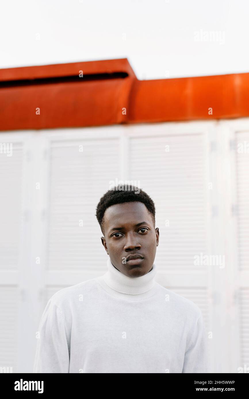 Confident young man wearing white turtleneck Stock Photo