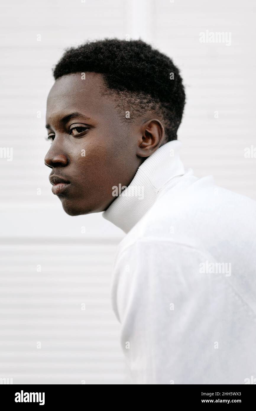Confident young man wearing white turtleneck Stock Photo
