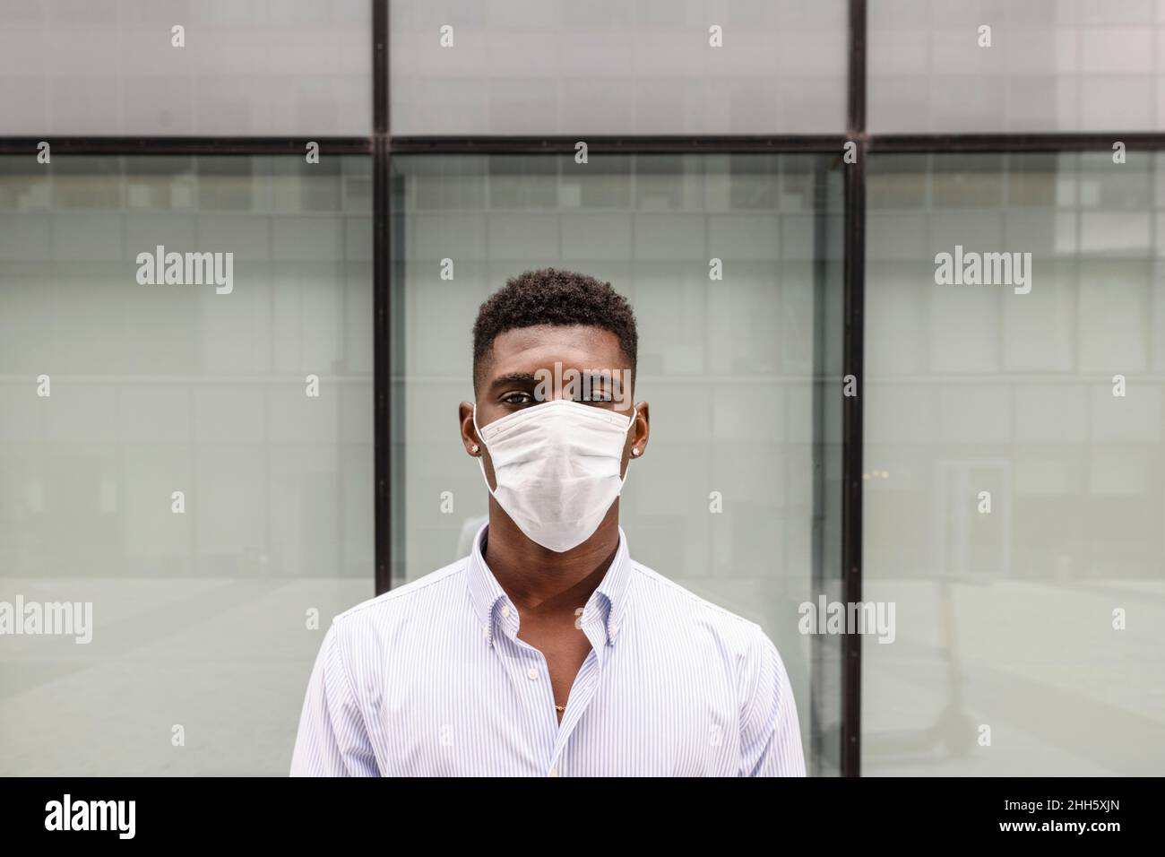 Young man wearing protective face mask Stock Photo