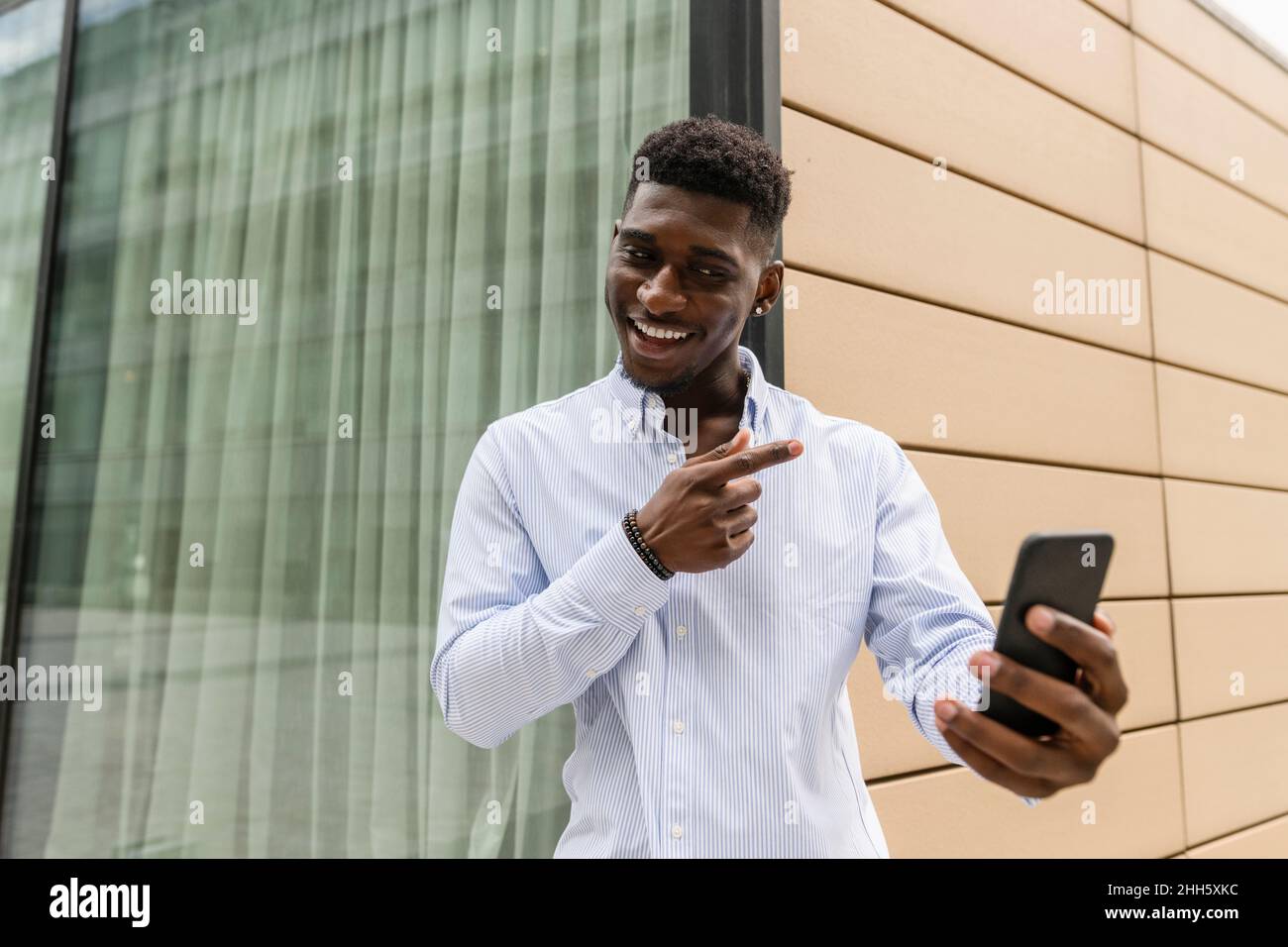 Smiling man on video call through smart phone Stock Photo
