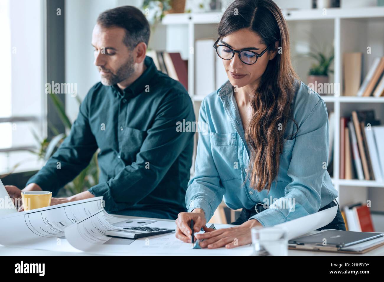 Architects working on desk in small office Stock Photo