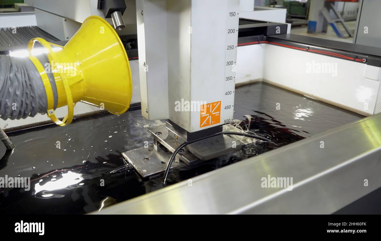 Metal cutting under water at factory. Scene. Processing of steel part