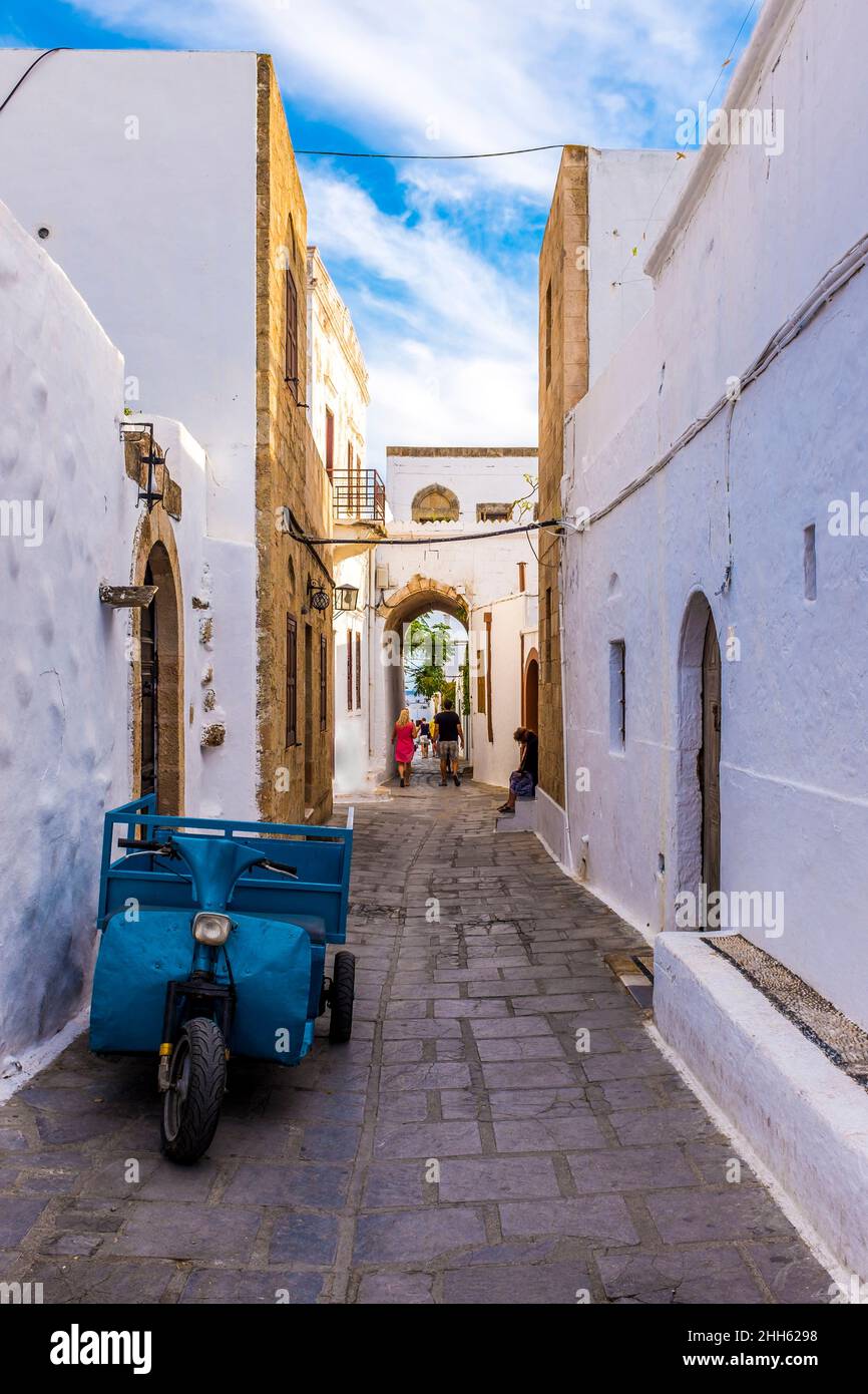 Blue motorized tricycle in whitewashed alley Stock Photo
