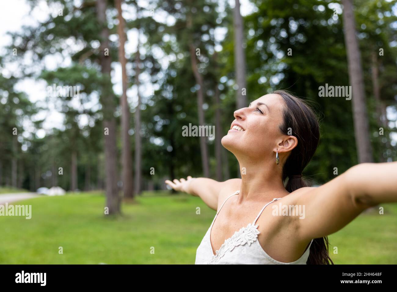 Woman with arms up side view hi-res stock photography and images - Alamy