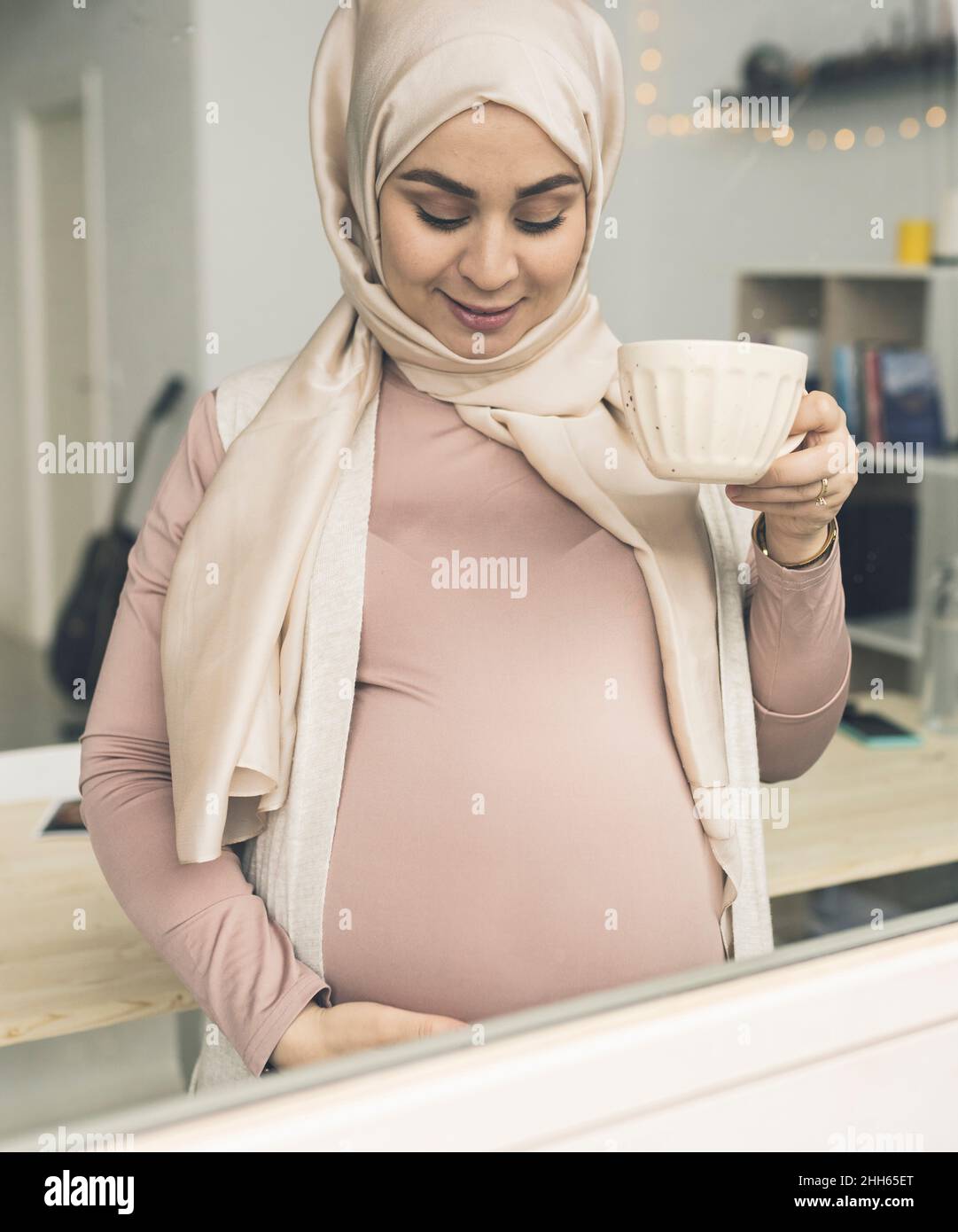 Pregnant woman with coffee cup seen through window Stock Photo Alamy