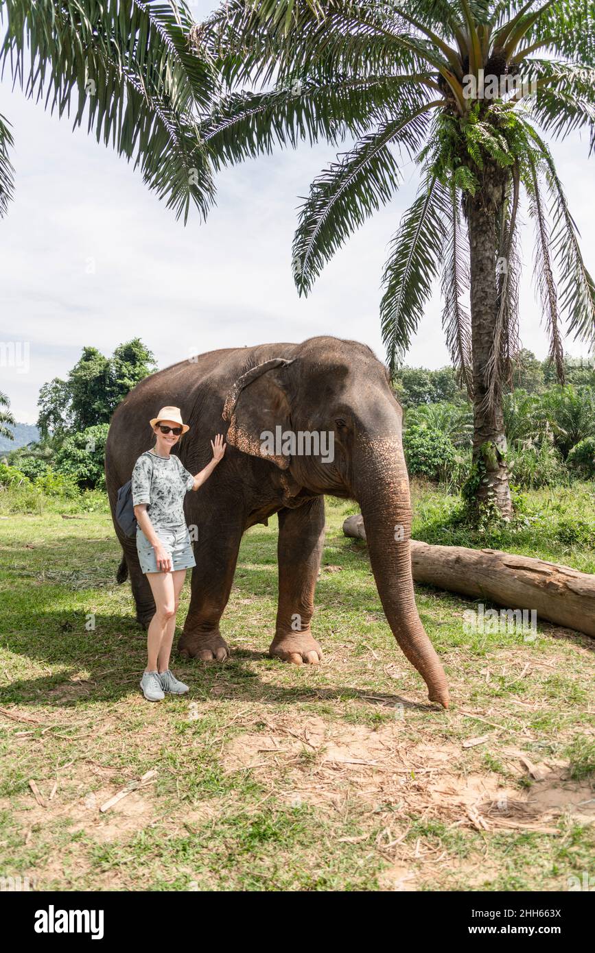 Woman standing elephant hi-res stock photography and images - Alamy