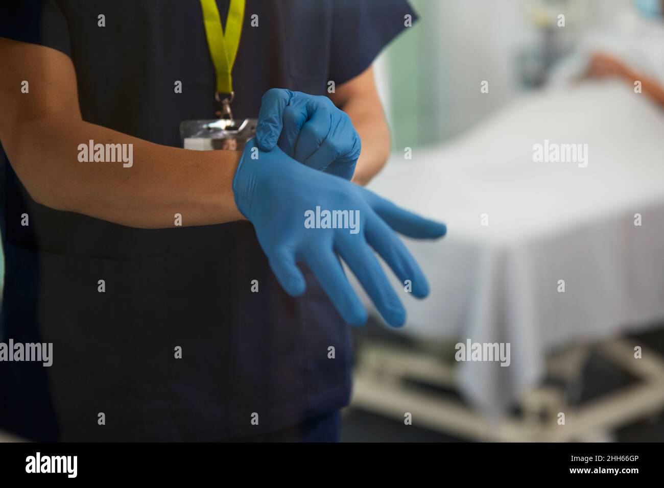 Healthcare worker wearing glove in medical room Stock Photo Alamy