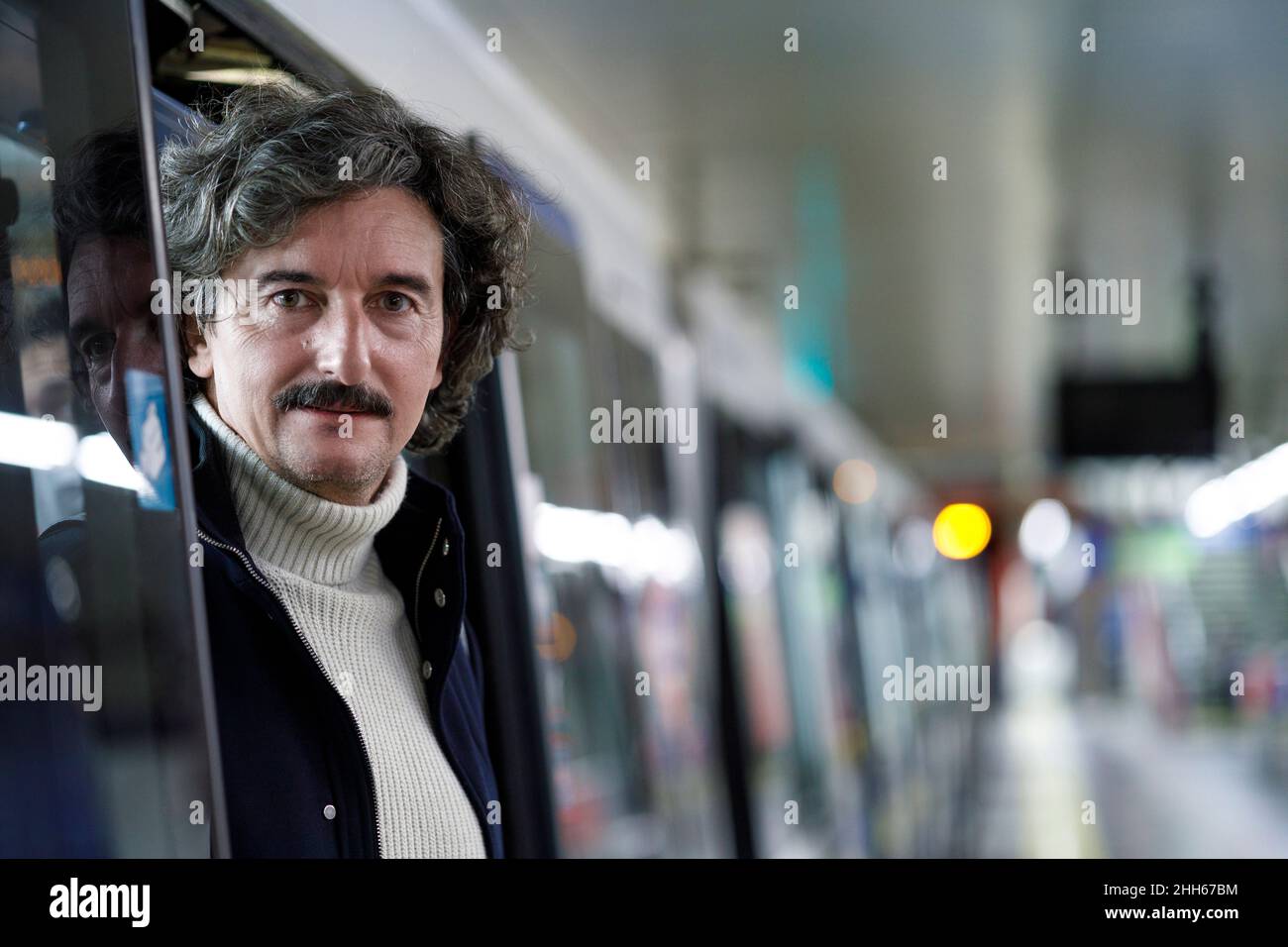 Man disembarking from subway train at station Stock Photo