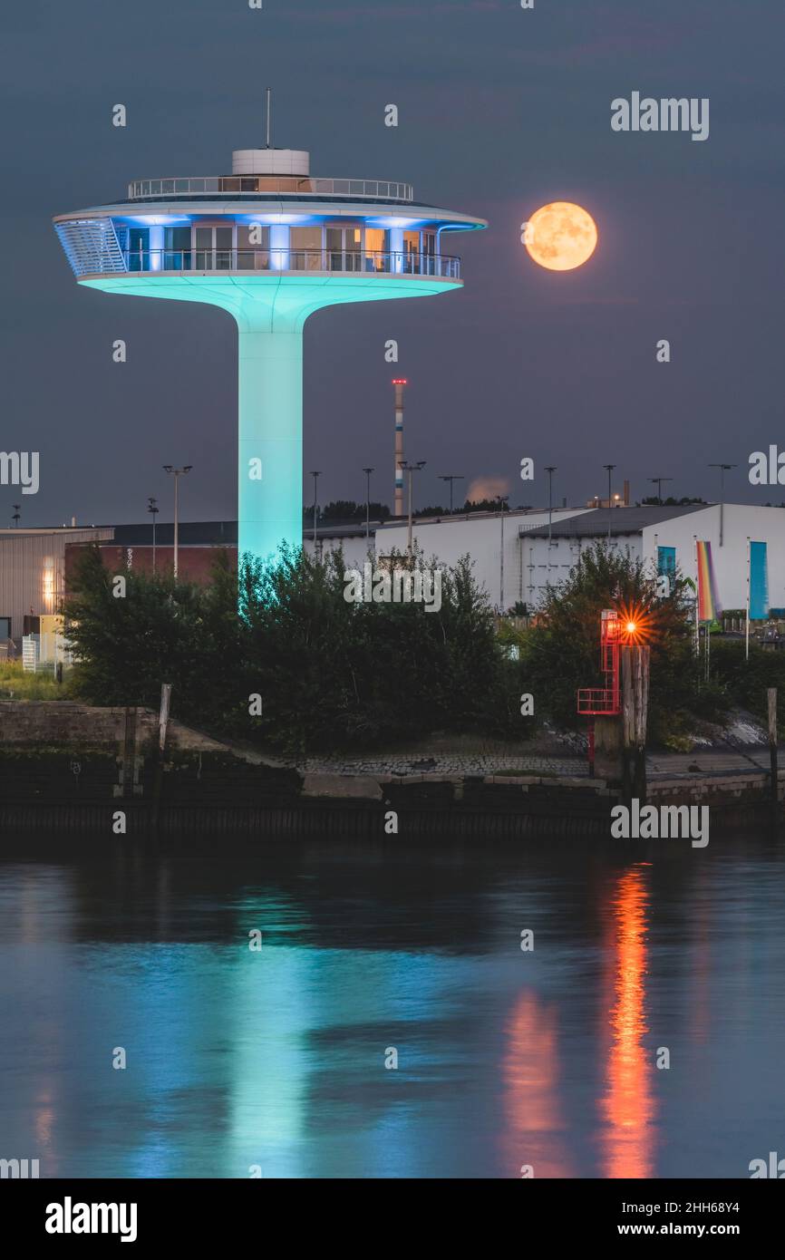 Germany, Hamburg, Lighthouse Zero building at night with ominous full moon in background Stock Photo