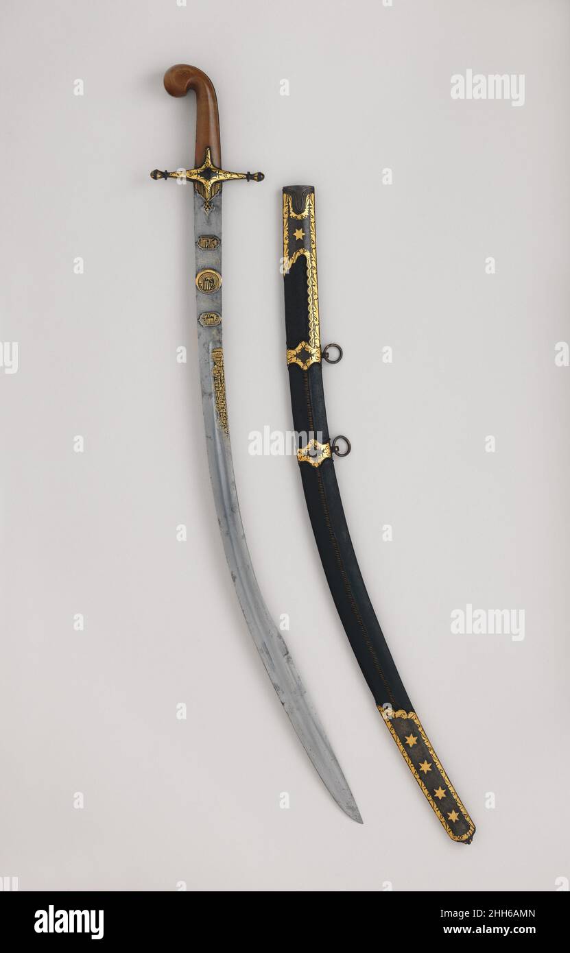 Saber (Kilij) with Scabbard hilt and scabbard, 19th century; blade, probably late 18th–early 19th century Hilt, Turkish or North African; blade, Iranian This type of Ottoman saber, with its distinctive curled “pistol grip” and cruciform guard, was used throughout Turkey and North Africa from the eighteenth century. Following Napoleon’s invasion of Egypt in 1798, the type, widely referred to as a “Mamluk” saber, became popular for European and North American officers’ swords and remains in use today. The blade of this example bears the false signature of Haji Sunqur, a legendary swordsmith acti Stock Photo